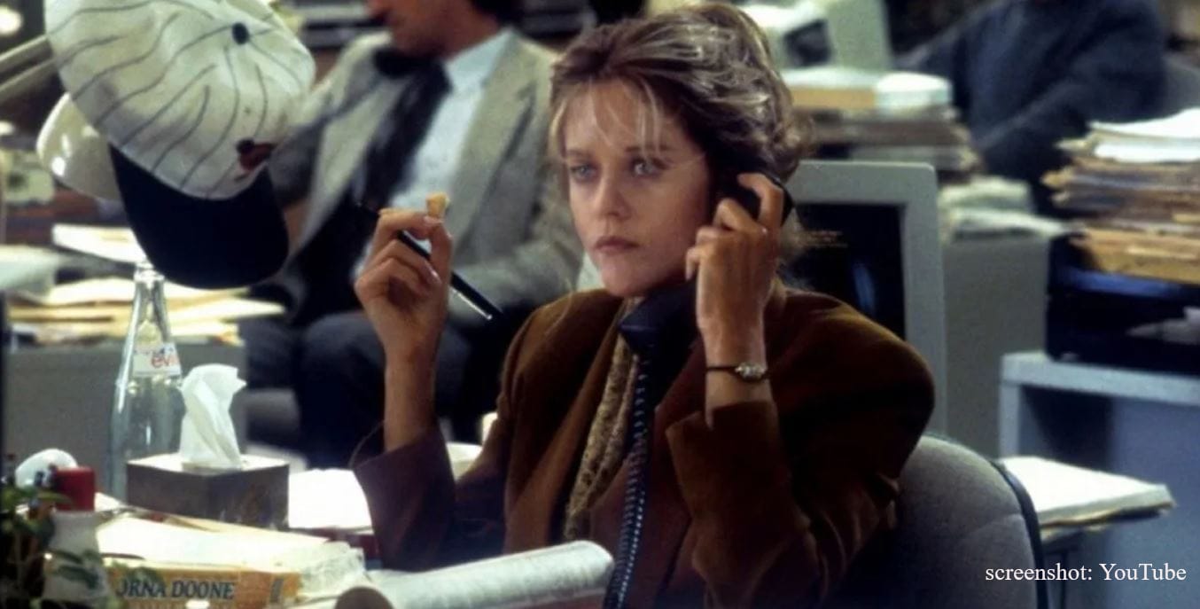 Meg Ryan as reporter Annie Reed, on the phone and munching a Lorna Doone cookie