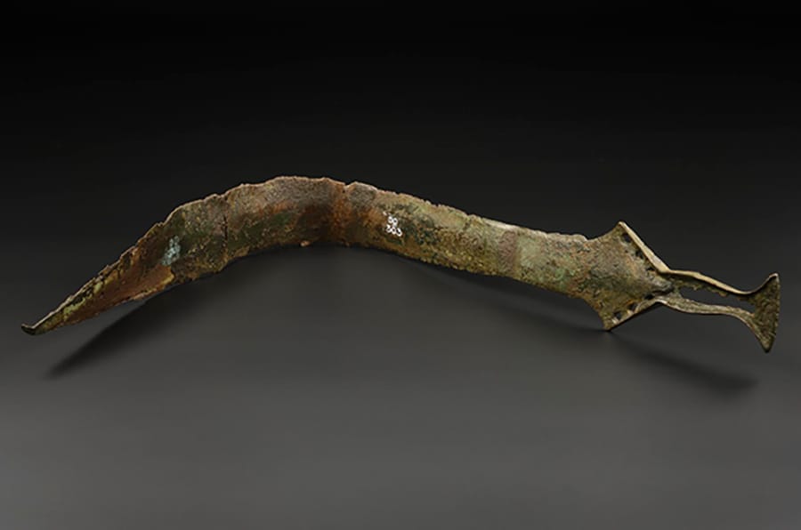 A bent, corroded, ancient sword from a Scottish museum
