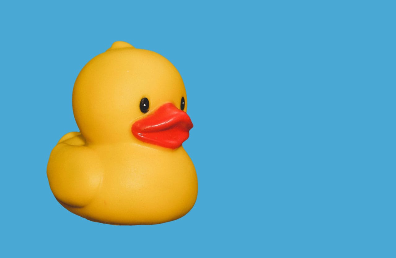 a nice lil rubber ducky on a background of limpid blue
