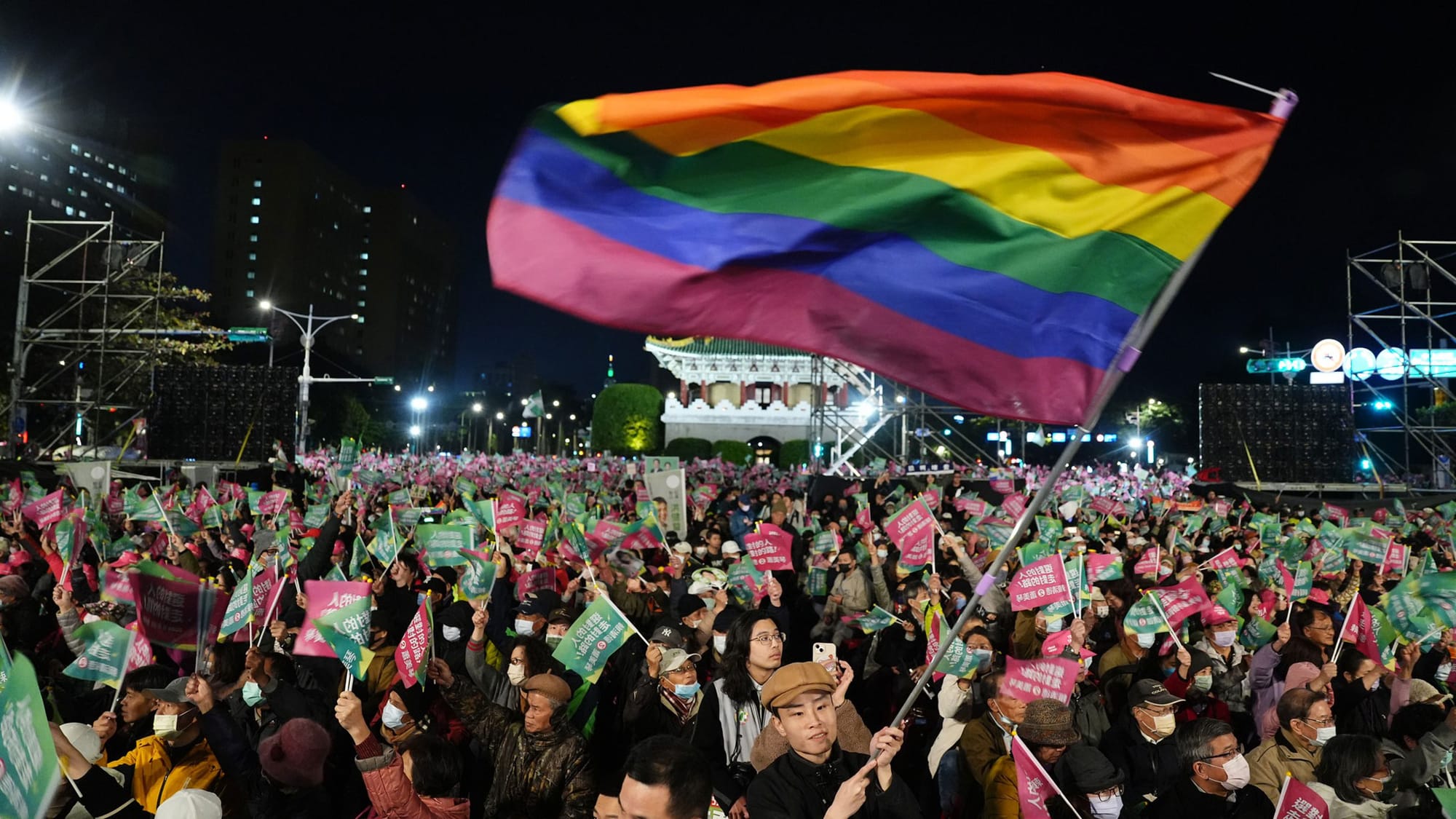 A huge pride flag unfurled over a a big crowd of DPP supporters at a rally in Taiwan