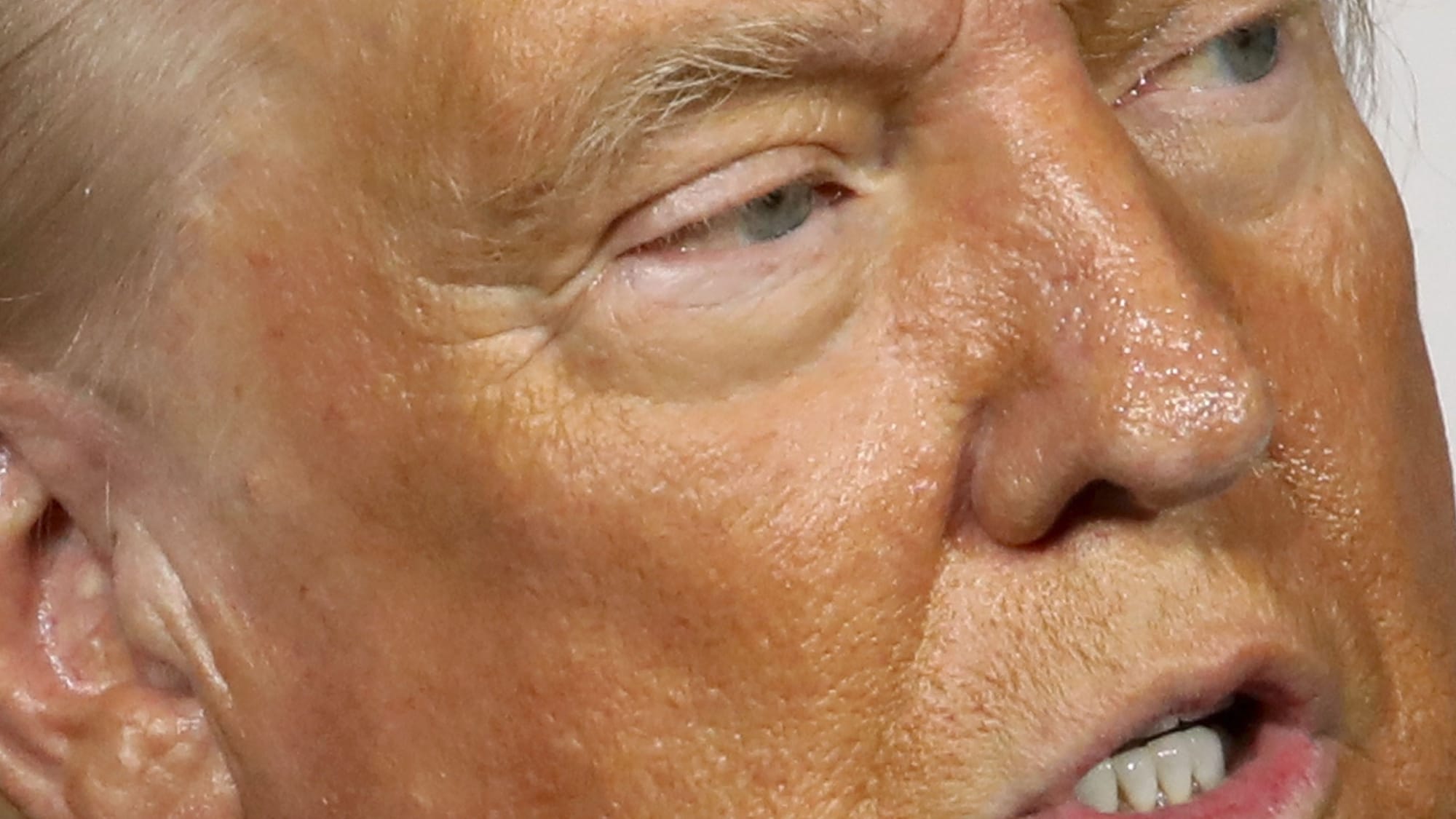 Donald Trump, multicolored, shiny, very close up face, speaking at a rally in Arizona