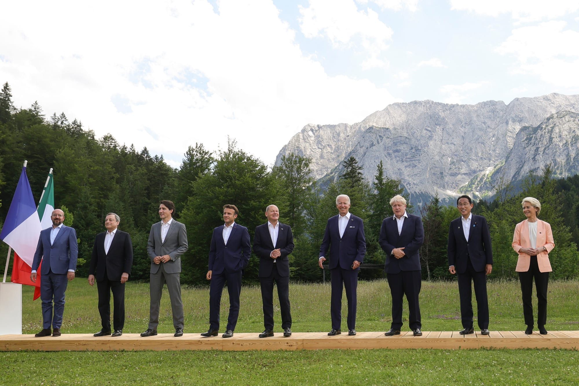 (L-R) G7 world leaders European Council President Charles Michel, Italian PM Mario Draghi, Canadian PM Justin Trudeau, French President Emmanuel Macron, German Chancellor Olaf Scholz, U.S. President Joe Biden, UK PM Boris Johnson, Japan's PM Fumio Kishida and European Commission President Ursula von der Leyen pose during the 2022 G7 Summit in Schloss Elmau in the Bavarian Alps. All excepting von der Leyen are wearing dark suits, dark shoes, and light shirts unbuttoned at the throat, with no ties