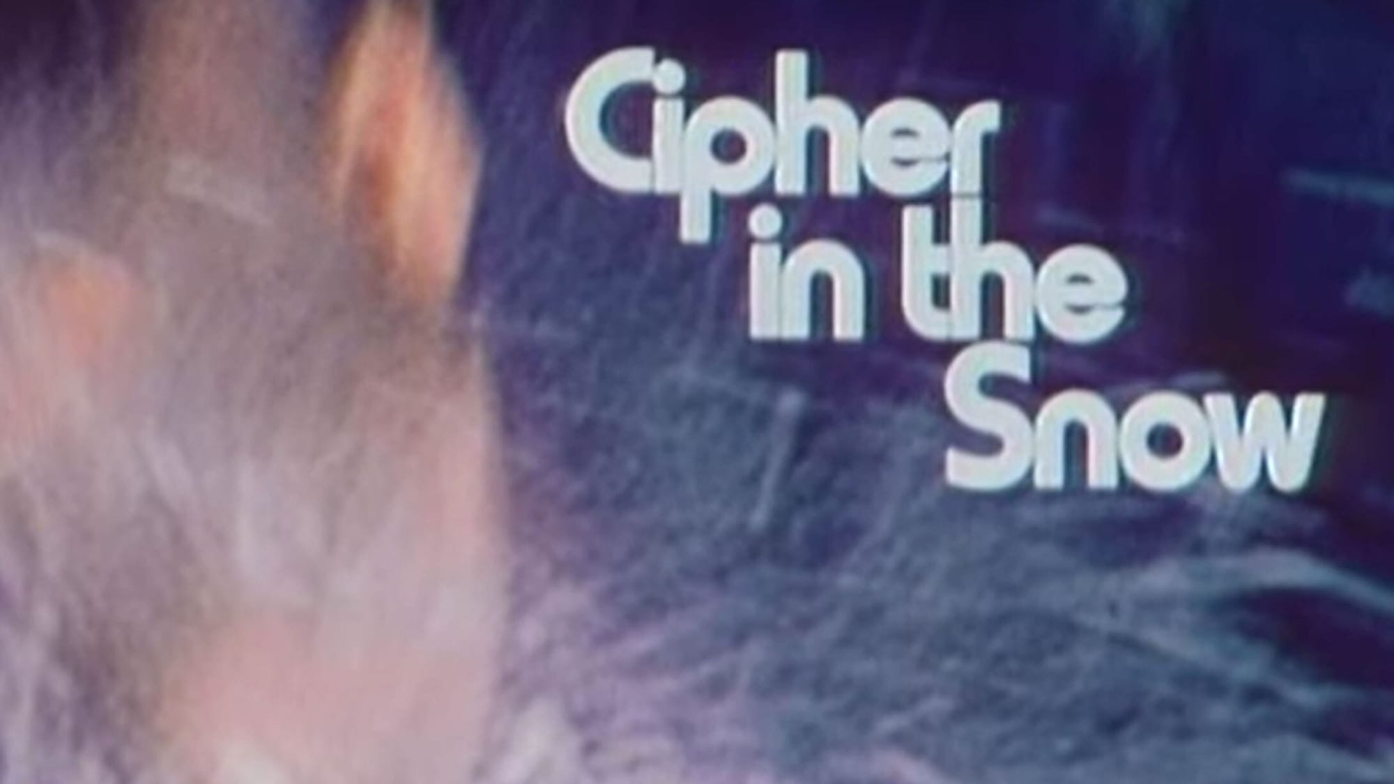 A blurry image of a boy falling face-first into the snow. The title reads “Cipher in the Snow” in a seventies style font 