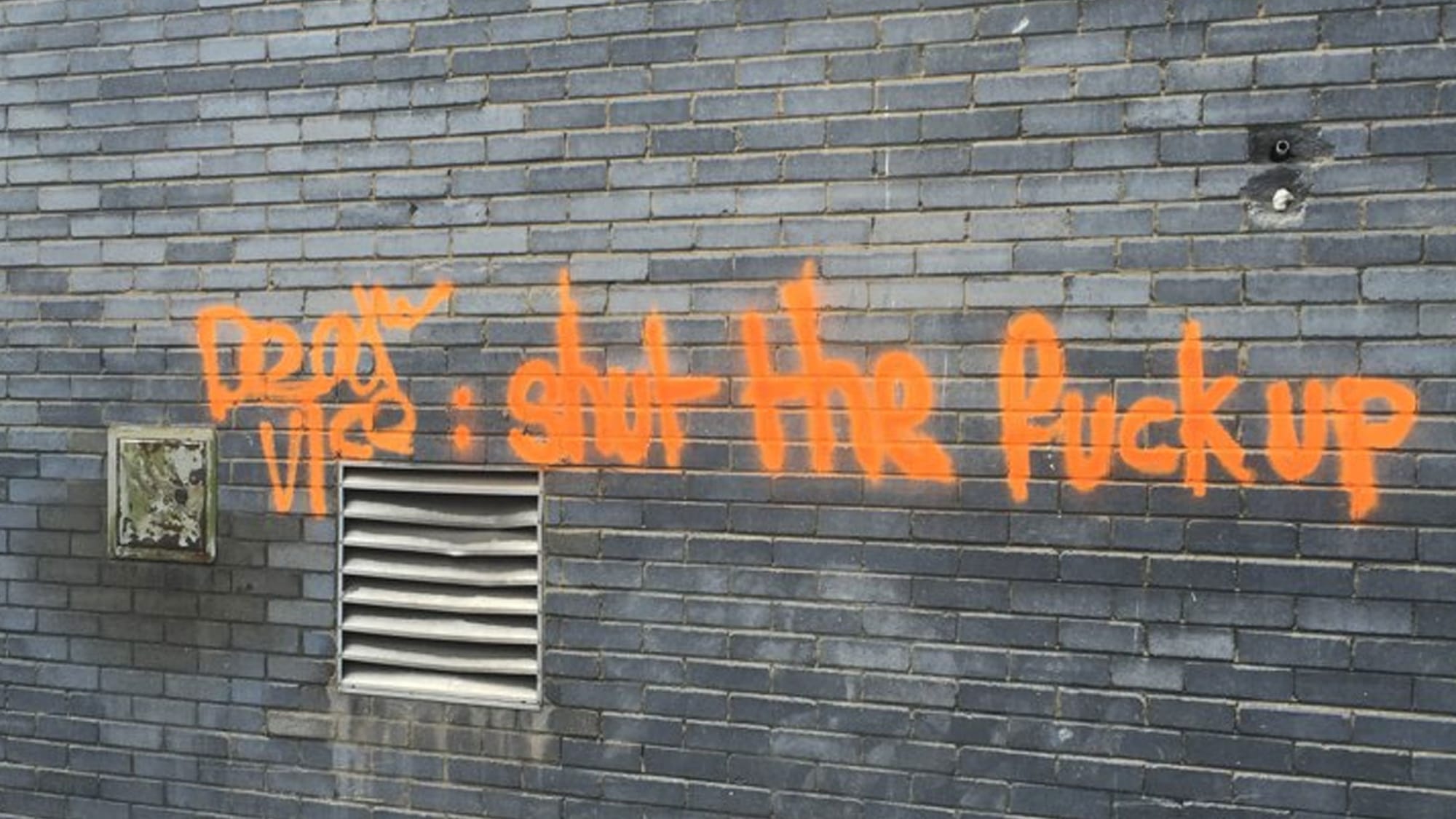 Dear Vice: shut the fuck up': A graffito on exterior wall of gray brick at Vice Magazine HQ, London, 2015