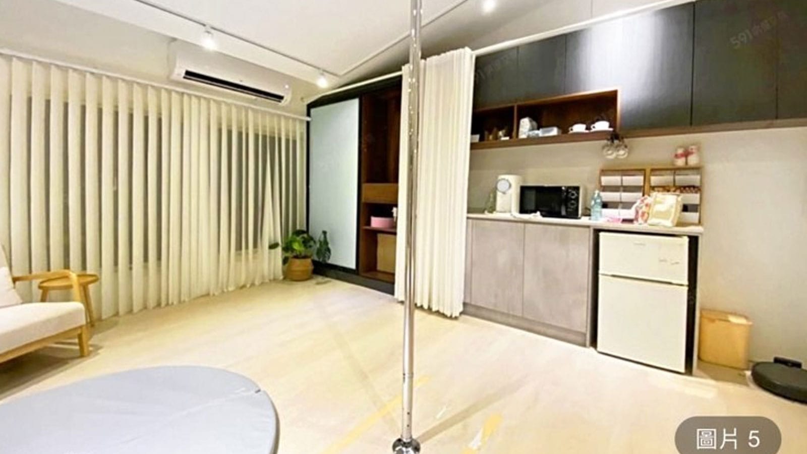 A Taipei apartment with a stripper pole in the center of the main room