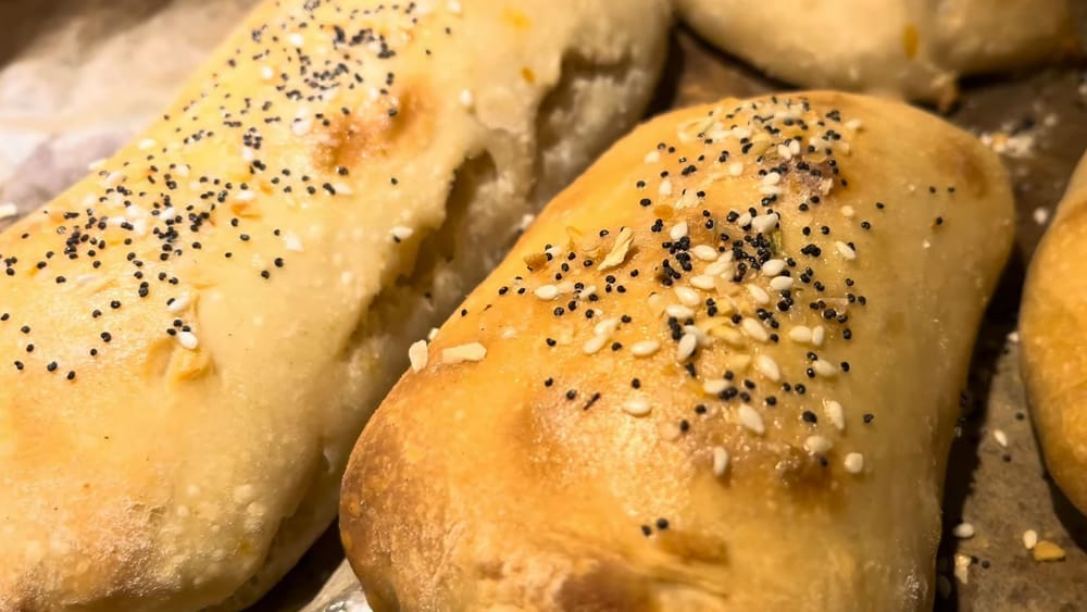 Confusingly asymmetrical rolls, unevenly baked, and haphazardly sprinkled with sesame and poppy seeds