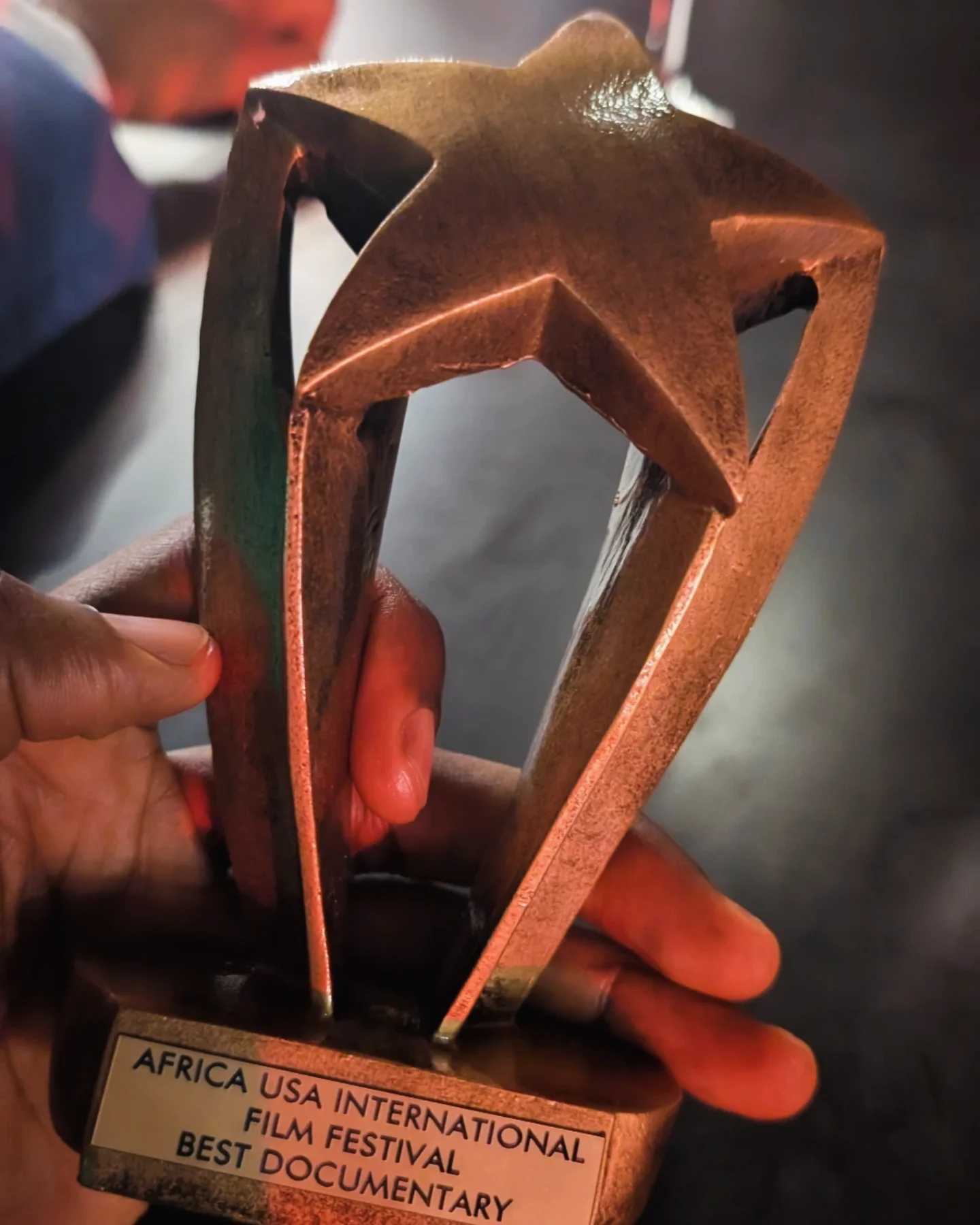 Kọ́lá Túbọ̀sún holding the Best Documentary award for 'Ebrohimie Road' at the Africa USA International Film Festival, Los Angeles