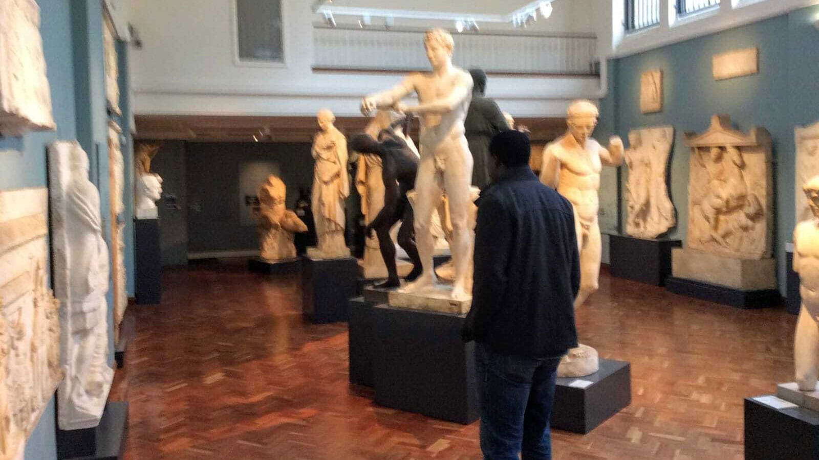 The author standing in a gallery of ancient statuary at the Ashmolean Museum, Oxford