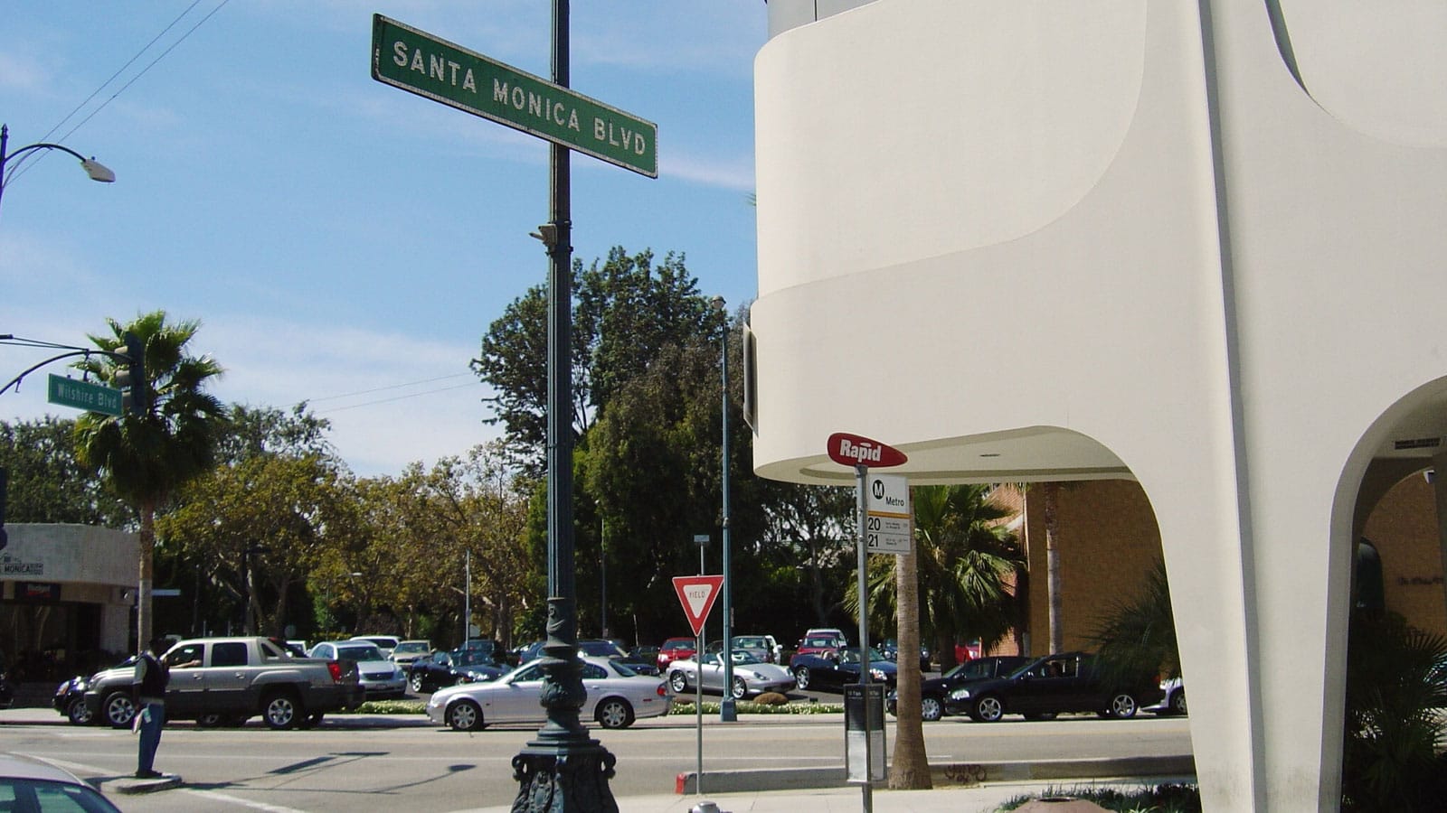 Santa Monica Boulevard on a beautiful sunny day in 2004, with palm trees, blue sky, and lots of cars