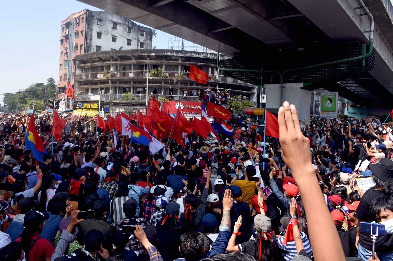 Protesters, many raising their hands in the Hunger Games pro-democracy salute, participate in an anti-military rally in downtown Yangon 